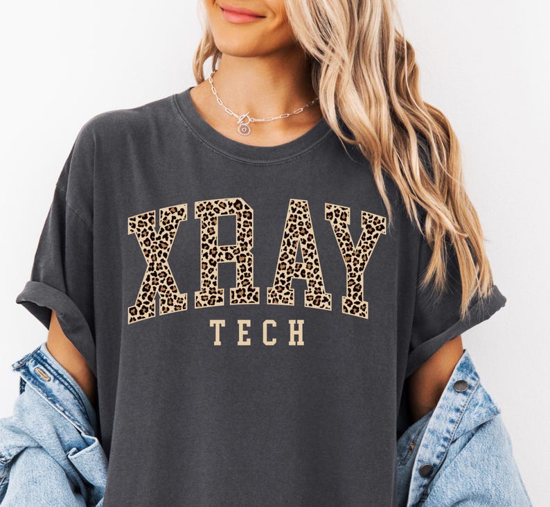 May include: A dark gray t-shirt with a leopard print "XRAY TECH" graphic.