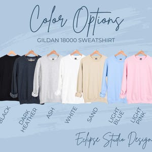 May include: A Gildan 18000 sweatshirt is shown in ten different colors: black, dark heather, ash, white, sand, light blue, light pink. The text "Color Options" and "Gildan 18000 Sweatshirt" is displayed above the sweatshirts. The text "Eclipse Studio Design" is displayed below the sweatshirts.