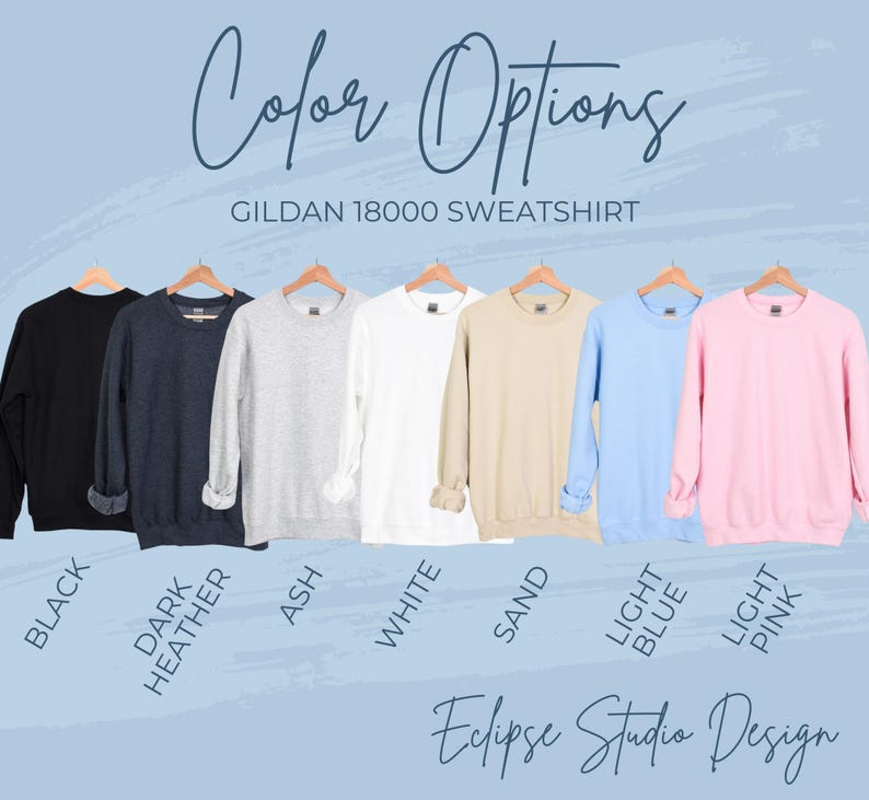 May include: A Gildan 18000 sweatshirt is shown in ten different colors: black, dark heather, ash, white, sand, light blue, light pink. The text "Color Options" and "Gildan 18000 Sweatshirt" is displayed above the sweatshirts. The text "Eclipse Studio Design" is displayed below the sweatshirts.