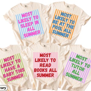 May include: Five ivory-colored t-shirts with various text designs. Each shirt features a different phrase in a colorful, striped box: "Most Likely to Sleep in All Summer," "Most Likely to Be at the Pool All Summer," "Most Likely to Have a Baby This Summer," "Most Likely to Read Books All Summer," and "Most Likely to Tutor All Summer."