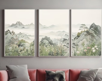 May include: Three framed landscape paintings depicting a misty mountain scene with green trees and rocks. The paintings are hung on a gray wall above a pink velvet sofa with gray pillows.