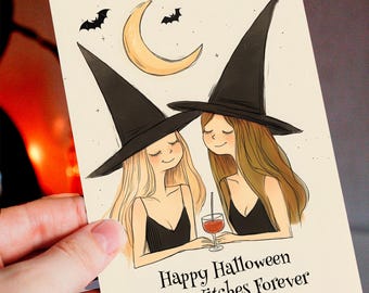 May include: A Halloween greeting card featuring two cartoon witches with long hair and black witch hats. The card has a crescent moon, bats, and the text "Happy Halloween Best Witches Forever."