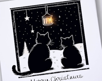 Puede incluir: Una tarjeta de Navidad en blanco y negro con dos gatos mirando por una ventana a una linterna y estrellas brillantes. El texto "Merry Christmas" está en la parte inferior de la tarjeta.