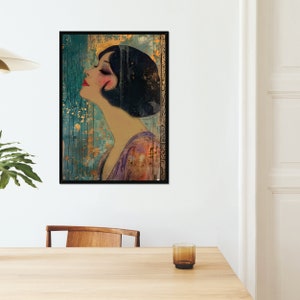 May include: A framed art print featuring a woman in profile with a bob haircut, wearing a purple dress. The artwork has a vintage style with a teal and gold background and a black frame. The woman has red lips and closed eyes.