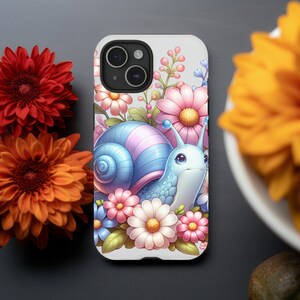 May include: A white phone case with a colorful illustration of a snail with pink and blue shell surrounded by pink, white, and yellow flowers.