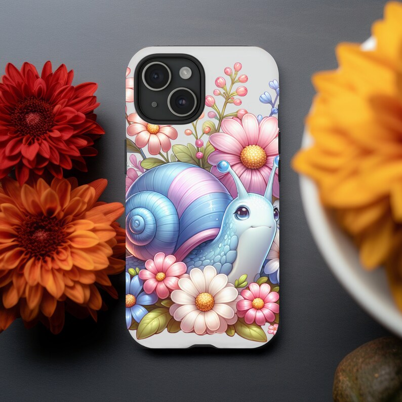 May include: A white phone case with a colorful illustration of a snail with pink and blue shell surrounded by pink, white, and yellow flowers.
