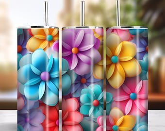 May include: Three stainless steel tumblers with colorful paper flower designs. The tumblers have lids and straws. The flowers are in shades of blue, purple, yellow, pink, and red.