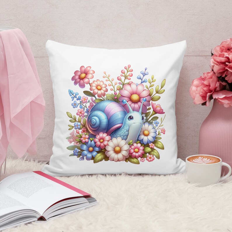 May include: A white pillow with a colorful illustration of a snail surrounded by pink, blue, and white flowers. The snail has a blue shell with pink accents and a light blue body.