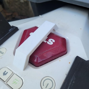 May include: White plastic handle on a white and red device with a red button that says "Start".