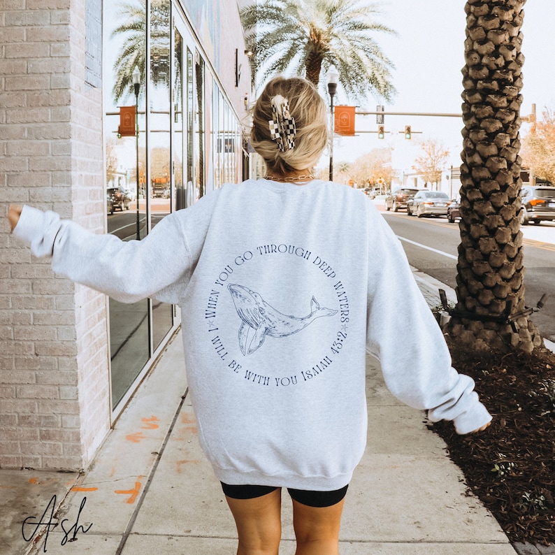 May include: Gray sweatshirt with a blue whale graphic and the text "When you go through deep waters I will be with you Isaiah 43:2".