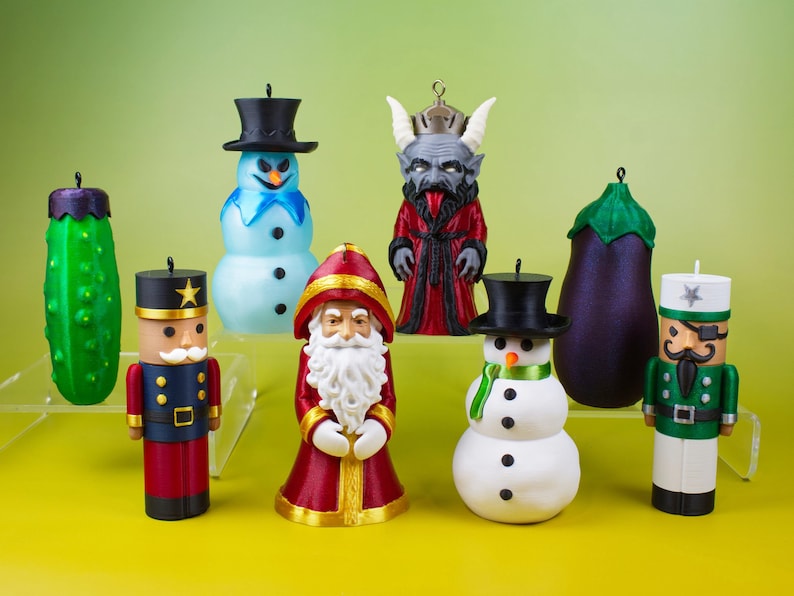 All eight Naughty and Nice stash ornaments arranged against a yellow-green background, a playful lineup of Christmas dopamine decor including the snowman, pickle, nutcracker, and Krampus.