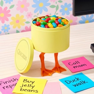 May include: A set of three ceramic mugs with a speckled, matte finish. The mugs are in shades of cream, light gray, and dark gray. Each mug has a simple, minimalist design, perfect for coffee or tea.