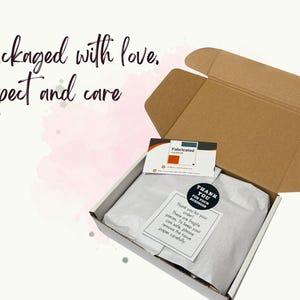 A neatly wrapped white gift box showing the shop's careful packaging, ready to arrive safely as an ideal Christmas gift.