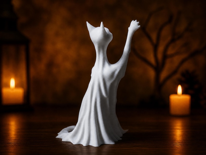 The rear view of the reaching ghost cat statue, showing the details of its spectral sheet. This eerie shelf sitter rests on a rustic wood surface.