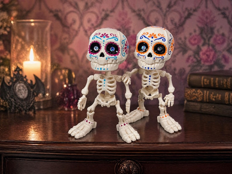 Two articulated skeletons standing side by side in a moody setting with a lit candle glowing softly in the background. These sugar skull figures serve as an evocative gothic home accent and a vibrant calavera art piece. Crafted as a tactile sensory item, this creepy cute pastel goth desk buddy is a fantastic witchy gift for friend. A wonderfully macabre weirdcore accessory and coworker gag gift that brings magic to any maximalist cubicle.