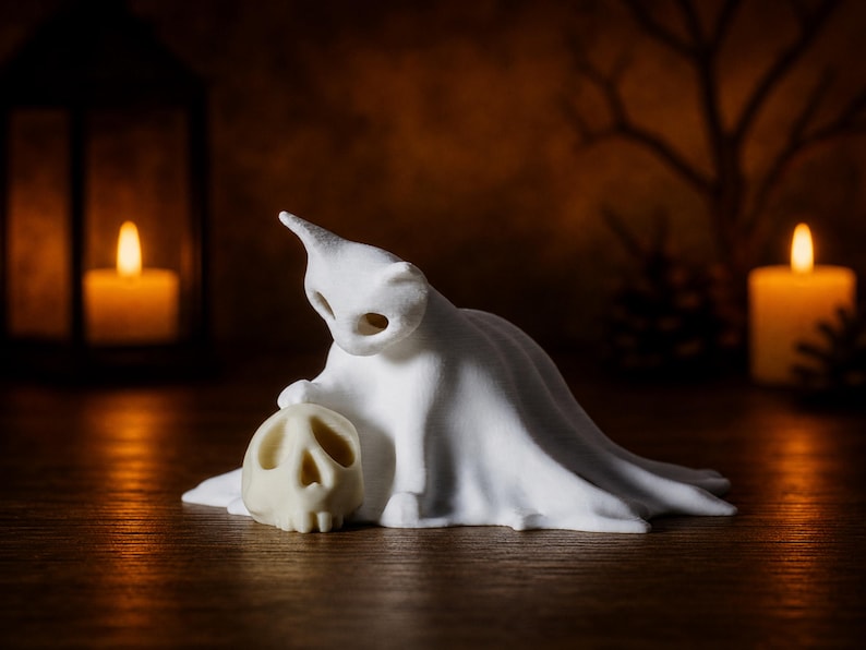 A close-up of the small kitten ghost cat resting its paw on a tiny skull, sitting on a wooden surface with a soft candlelight background, perfect for a witchy autumn vibe.