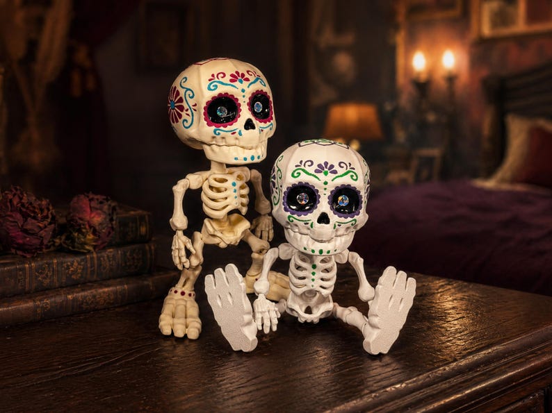 Two creepy cute pastel goth desk buddies resting on a wooden surface against a moody gothic background. One articulated skeleton stands tall while the other sits, showcasing the flexible joints of this weirdcore desk fidget toy. This sugar skull figure makes a perfect gothic home accent or a unique coworker gag gift for those who appreciate fun dopamine decor. A highly tactile sensory item decor piece ready to elevate your maximalist cubicle.