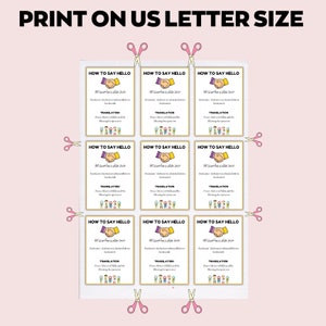 May include: A sheet of printable cards with the text "HOW TO SAY HELLO" in English and Arabic, with a handshake graphic. The cards are arranged on a pink background with pink scissors around the edges. The text "PRINT ON US LETTER SIZE" is at the top.