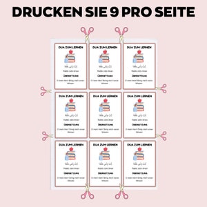 May include: A printable sheet with nine small cards, each featuring text in Arabic and German. The cards have a red border and include illustrations of books, pencils, and apples. Pink scissors are placed around the cards.