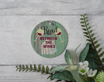 Bookish Wine Lover ceramic Christmas ornament-Read between the wines!- Use as a gift tag for your favorite book-tro-vert! Cheers to Reading!