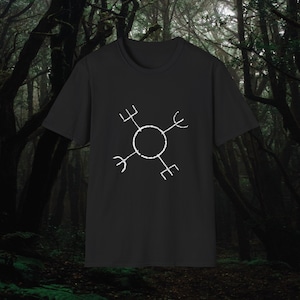 May include: Black t-shirt with a white symbol of a circle with four spokes, each spoke has three prongs. The symbol is centered on the shirt.