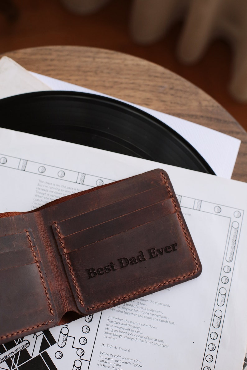 The handmade leather wallet, which is 3.5 inches wide and 4.3 inches tall, has 10 card pockets and 1 cash pocket, is available in 6 different colors: brown, light brown, red, gray, blue, green and black. The personification on it is laser engraved.