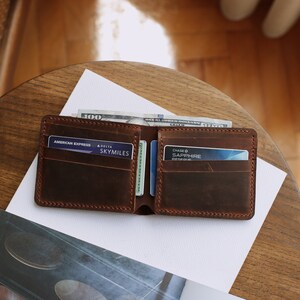 The handmade leather wallet, which is 3.5 inches wide and 4.3 inches tall, has 10 card pockets and 1 cash pocket, is available in 6 different colors: brown, light brown, red, gray, blue, green and black. The personification on it is laser engraved.