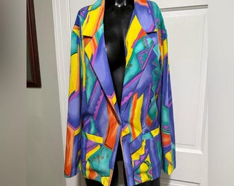 May include: A colorful blazer with a vibrant abstract design. The jacket features a mix of yellow, purple, orange, and teal geometric shapes. It has a classic notched collar, long sleeves, and two front pockets. The blazer is displayed on a black mannequin.