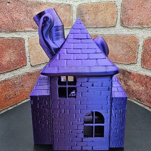 May include: A purple 3D printed house with a brick pattern and a whimsical, tentacled chimney. The house has two windows with black frames.