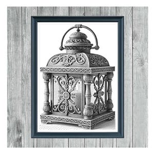 May include: A framed monochrome cross-stitch pattern of a rustic lantern. The lantern has detailed ornamentation, a handle, and a decorative top. The frame is dark blue, set against a gray wooden background. Text at the top reads "RUSTIC LANTERN 1".