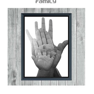 May include: Black and white cross stitch pattern of three hands forming a heart shape, framed in a black frame against a woodgrain background. The title "FAMILY" is above the frame and "MONOCHROME CROSS STITCH PATTERN" is below the frame.