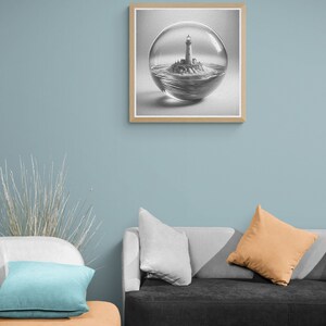 May include: A black and white drawing of a lighthouse on a small island inside a glass sphere. The drawing is framed in a light wood frame and hanging on a light blue wall.