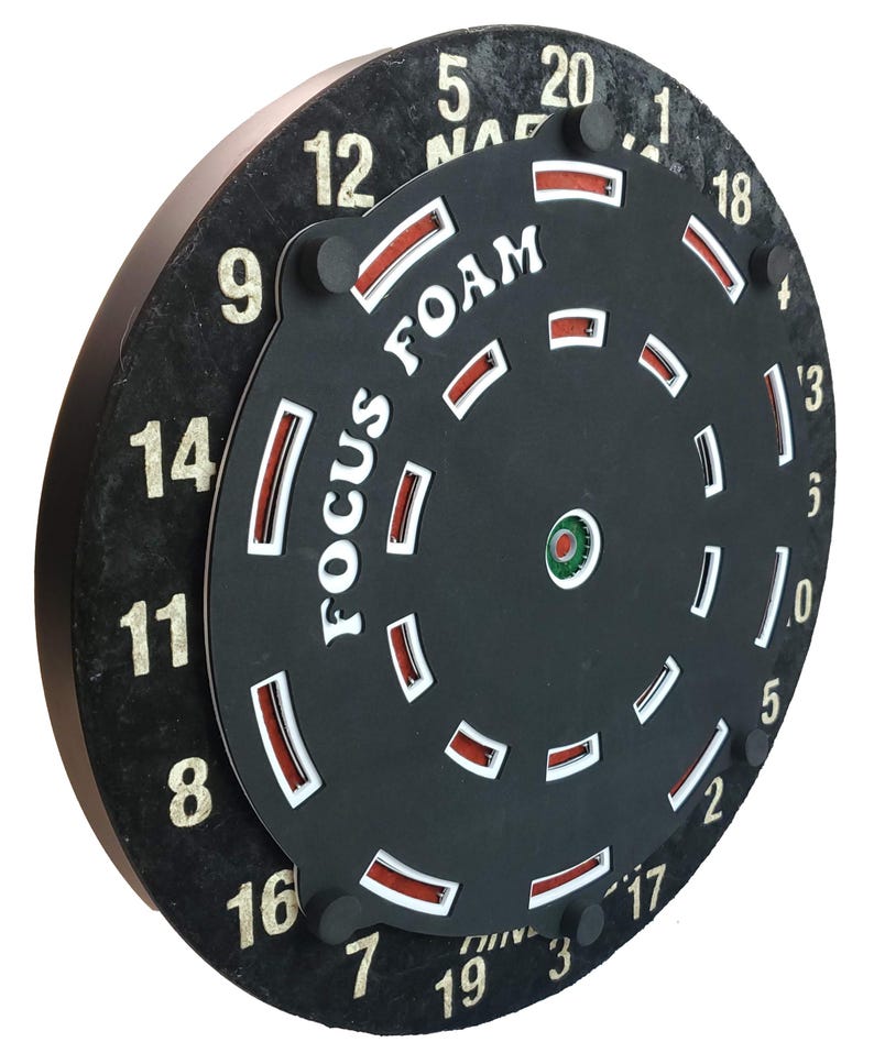 May include: A black dartboard with white numbers and a red and white foam target with the text "FOCUS FOAM" printed on it.