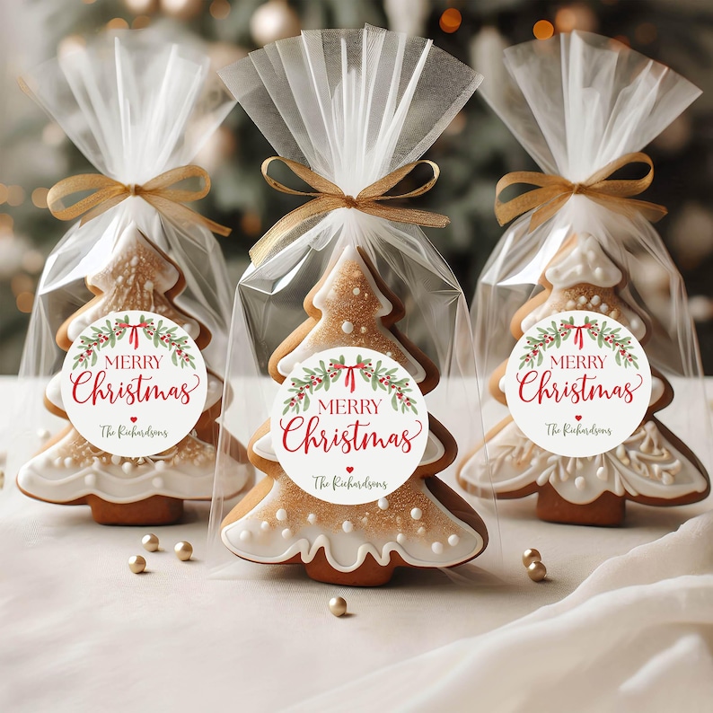 May include: Three Christmas tree-shaped cookies in clear cellophane bags tied with gold ribbons. Each bag features a round white sticker with a green holly wreath, red berries, and the text Merry Christmas and The Richardsons.
