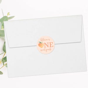 May include: A peach-colored round sticker with a peach illustration and the text "Olivia is one sweet peach".
