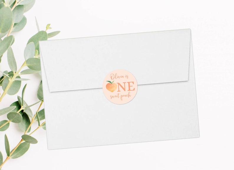 May include: A peach-colored round sticker with a peach illustration and the text "Olivia is one sweet peach".
