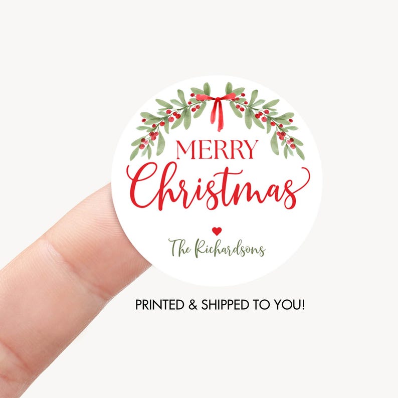 May include: A round white sticker featuring a watercolor illustration of green holly leaves and red berries arranged in a wreath with a red bow at the top. The text reads Merry Christmas in red script and print, followed by a small red heart and The Richardsons.