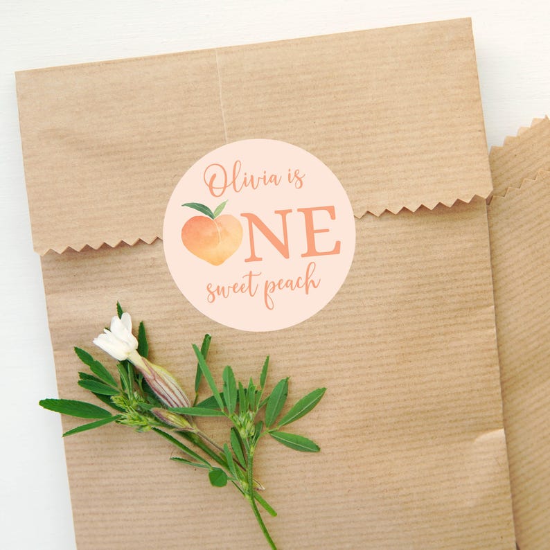 May include: A peach-colored circle sticker with a peach illustration and the text "Olivia is ONE sweet peach".