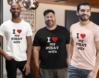 May include: Three men wearing t-shirts with the text "I love my Pinay wife" and a red heart. The shirts are white, black, and pink.