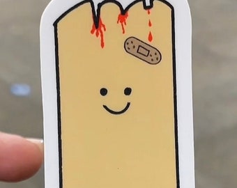May include: A yellow sticker with a cartoon stick figure with a bandage on its head and the text "STAND TEST SURVIVOR".
