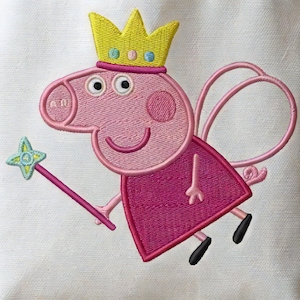 May include: Embroidered image of a cartoon pig wearing a yellow crown and a pink dress. The pig is holding a star-shaped wand and has pink fairy wings. The image is on a white background.