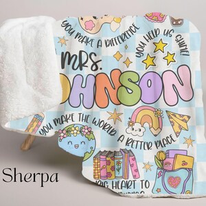 May include: A blue and white sherpa blanket with a colorful design featuring the text "You make a difference Mrs. Johnson You make the world a better place Big heart to learning" and various illustrations including stars, rainbows, pencils, books, and a globe.