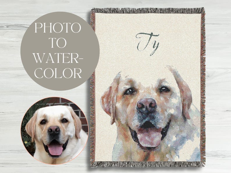 May include: A woven throw blanket featuring a watercolor portrait of a yellow Labrador Retriever. The dog's name, "Ty", is written in cursive. A smaller circular image of the dog is also present, along with the text "PHOTO TO WATER-COLOR".