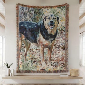 May include: Woven tapestry featuring a watercolor-style portrait of a dog with black, brown, and tan fur. The dog is standing in a forest setting, with the name "Mart" written in cursive. The tapestry has a fringed border.
