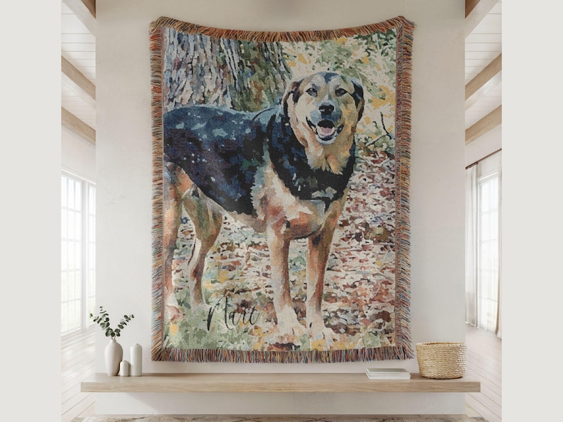 May include: Woven tapestry featuring a watercolor-style portrait of a dog with black, brown, and tan fur. The dog is standing in a forest setting, with the name "Mart" written in cursive. The tapestry has a fringed border.