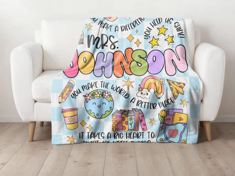 May include: A blue and white checkered fleece blanket with a colorful design featuring the text "You make a difference", "Mrs. Johnson", "You help us shine", "You make the world a better place", and "It takes a big heart to do what we do".