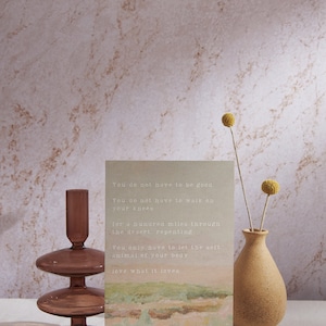 May include: A card with a watercolor background and text that reads: "You do not have to be good. You do not have to walk on your knees for a hundred miles through the desert, repenting. You only have to let the soft animal of your body love what it loves."