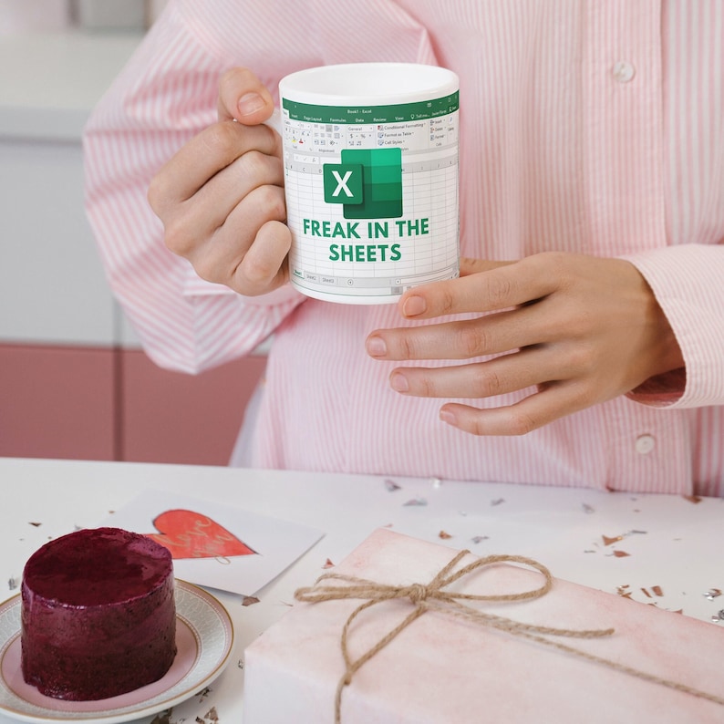 White ceramic 11oz Freak In The Sheets Excel mug with a graphic showing an Excel spreadsheet and the words Freak in the sheets. Perfect funny gift for a coworker, boss and friend. Perfect spicy Valentines Day Gifts!