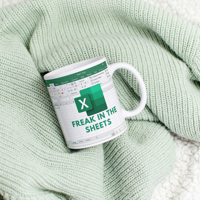 White ceramic 11oz Freak In The Sheets Excel mug with a graphic showing an Excel spreadsheet and the words Freak in the sheets. Perfect funny gift for a coworker, boss and friend.