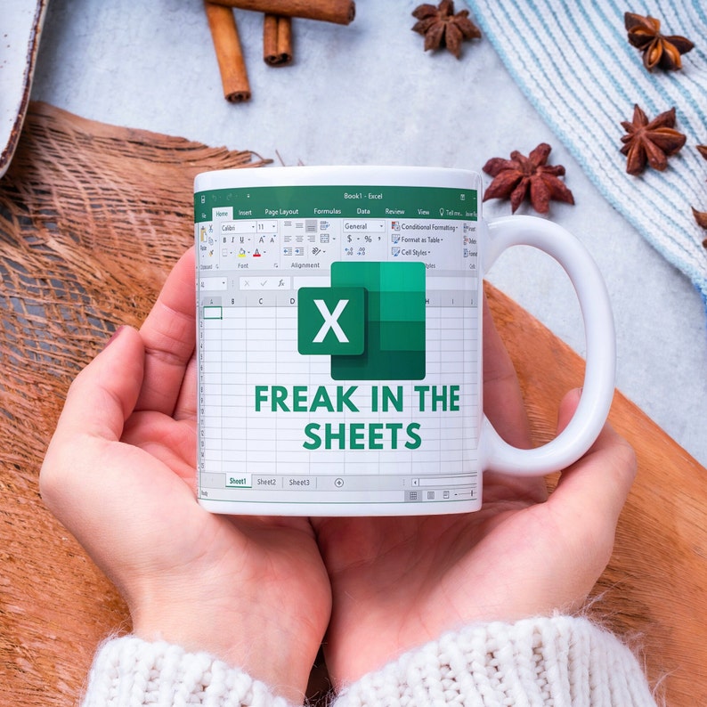 White ceramic 11oz Freak In The Sheets Excel mug with a graphic showing an Excel spreadsheet and the words Freak in the sheets. Perfect funny gift for a coworker, boss and friend.